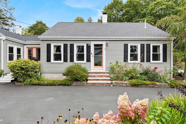 23 Amerescoggin Rd, Falmouth, ME 04105 - view of front of house featuring a chimney, a shingled roof, and entry steps