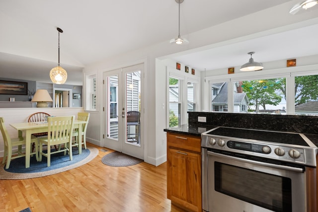 23 Amerescoggin Rd, Falmouth, ME 04105 - kitchen featuring stainless steel electric stove, french doors, plenty of natural light, brown cabinets, and vaulted ceiling
