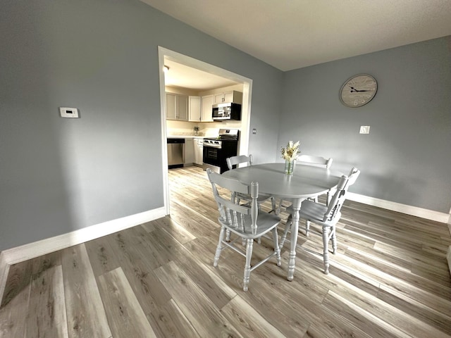 507 Waldo St, Rumford, ME 04276 - dining area featuring baseboards and light wood-style floors