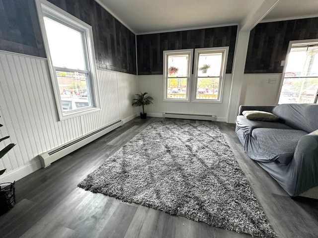 507 Waldo St, Rumford, ME 04276 - sitting room with a baseboard radiator, wood finished floors, and wooden walls