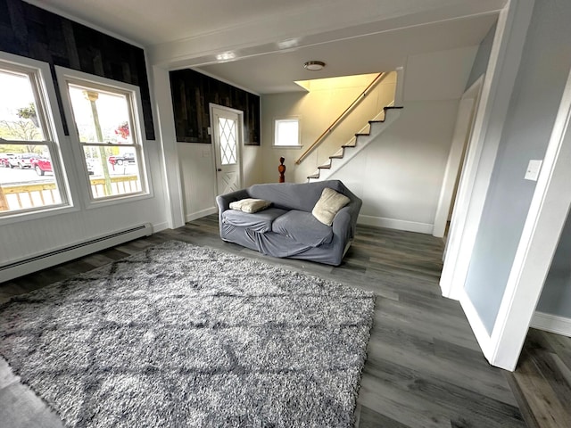 507 Waldo St, Rumford, ME 04276 - living room with stairway, wood finished floors, baseboards, and a baseboard heating unit