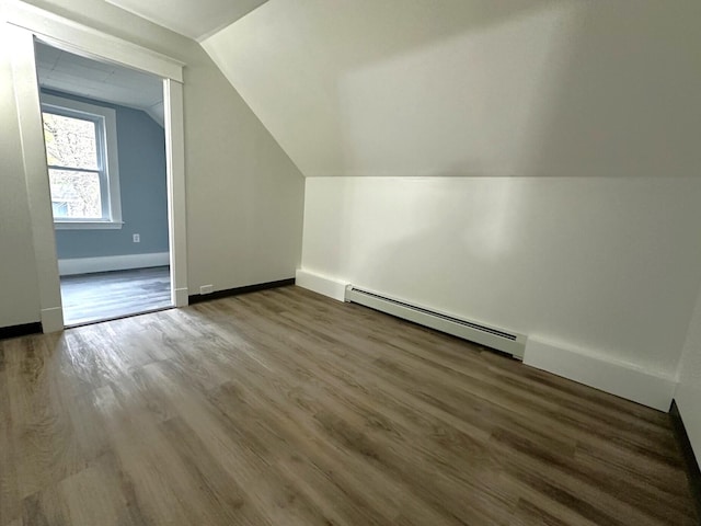 507 Waldo St, Rumford, ME 04276 - bonus room featuring a baseboard heating unit, vaulted ceiling, wood finished floors, and baseboards