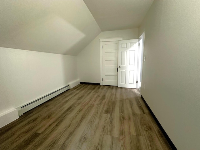 507 Waldo St, Rumford, ME 04276 - bonus room with baseboard heating, vaulted ceiling, wood finished floors, and baseboards