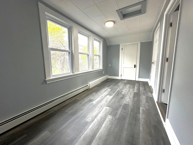 507 Waldo St, Rumford, ME 04276 - unfurnished room featuring a baseboard heating unit, dark wood-style flooring, and baseboards