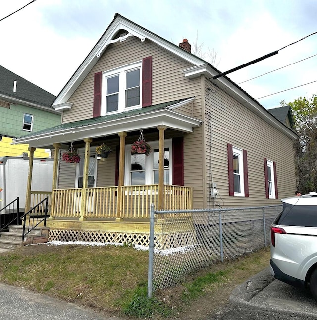 507 Waldo St, Rumford, ME 04276 - view of front of property with a porch, a chimney, and fence