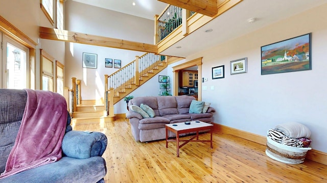 101 Parrott St, South Portland, ME 04106 - living room with a towering ceiling, hardwood / wood-style floors, stairway, and baseboards