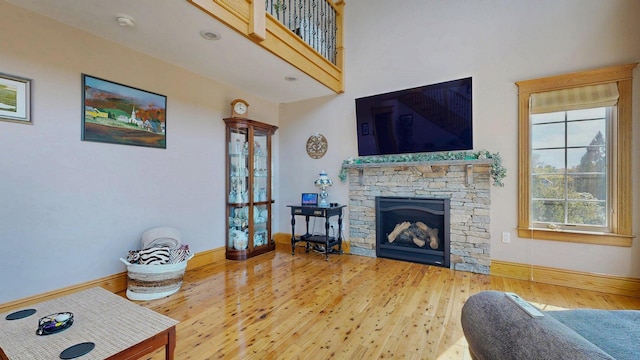 101 Parrott St, South Portland, ME 04106 - living room featuring wood finished floors, baseboards, and a stone fireplace
