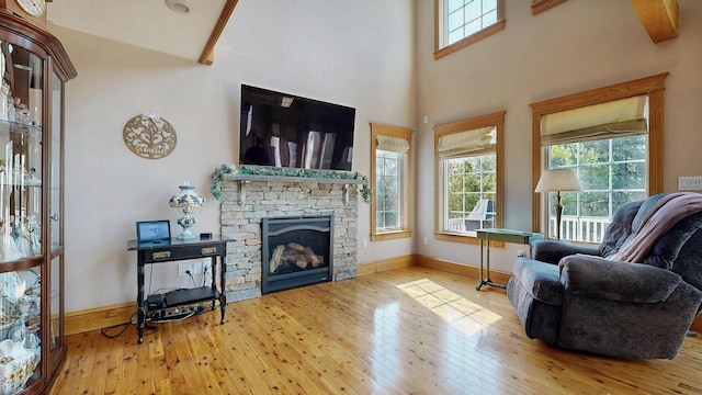 101 Parrott St, South Portland, ME 04106 - living room with hardwood / wood-style flooring, a fireplace, baseboards, and a high ceiling
