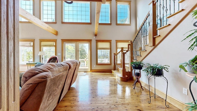 101 Parrott St, South Portland, ME 04106 - living area with hardwood / wood-style floors, a high ceiling, stairs, and baseboards