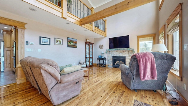 101 Parrott St, South Portland, ME 04106 - living area with hardwood / wood-style floors, a towering ceiling, a fireplace, baseboards, and recessed lighting