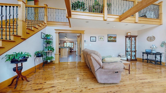 101 Parrott St, South Portland, ME 04106 - living area featuring wood finished floors, a towering ceiling, baseboards, and stairs