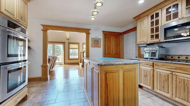 101 Parrott St, South Portland, ME 04106 - kitchen featuring stainless steel appliances, a kitchen island, glass insert cabinets, and stone countertops