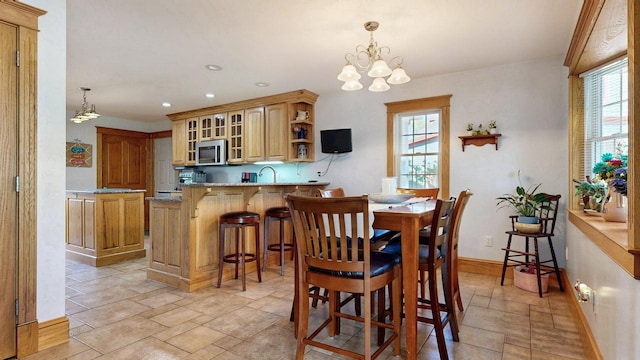 101 Parrott St, South Portland, ME 04106 - dining space with a chandelier, recessed lighting, light stone finish floors, and baseboards