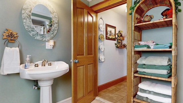 101 Parrott St, South Portland, ME 04106 - bathroom with tile patterned floors, a sink, and baseboards