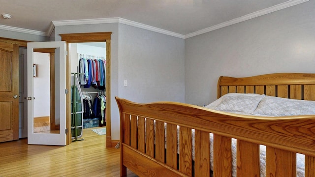 101 Parrott St, South Portland, ME 04106 - bedroom with a spacious closet, wood finished floors, a closet, ornamental molding, and baseboards
