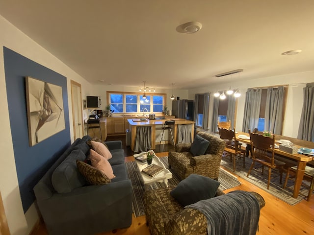 33 Latour St, Castine, ME 04421 - living room featuring wood finished floors and a chandelier