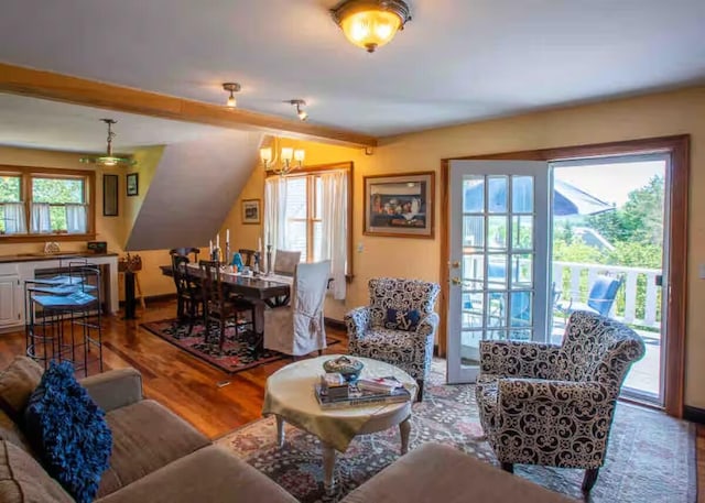 33 Latour St, Castine, ME 04421 - living area with a chandelier, wood finished floors, and baseboards