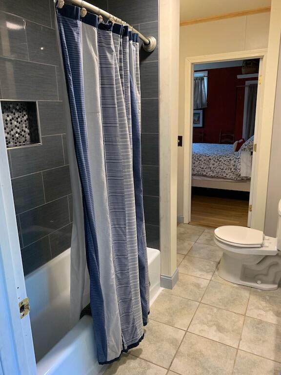 33 Latour St, Castine, ME 04421 - ensuite bathroom with shower / bath combo with shower curtain, tile patterned floors, and toilet