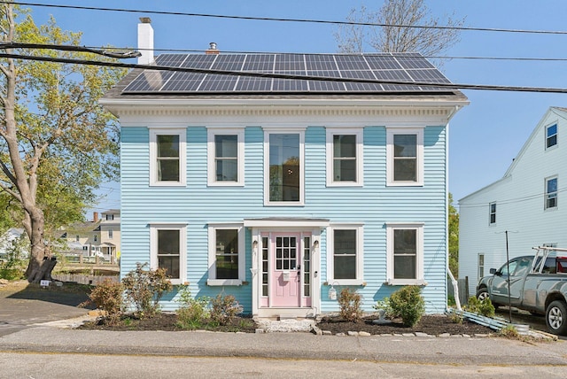 61 Granite St, Bath, ME 04530 - view of front facade featuring solar panels and a chimney