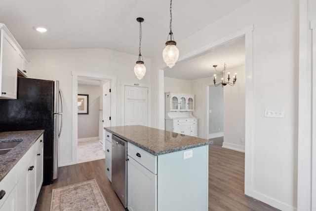 61 Granite St, Bath, ME 04530 - kitchen with appliances with stainless steel finishes, vaulted ceiling, dark wood-style flooring, a kitchen island, and white cabinetry