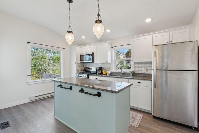 61 Granite St, Bath, ME 04530 - kitchen with stainless steel appliances, a baseboard heating unit, a center island, a sink, and backsplash
