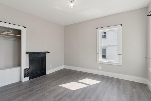 61 Granite St, Bath, ME 04530 - unfurnished living room with a fireplace, wood finished floors, and baseboards