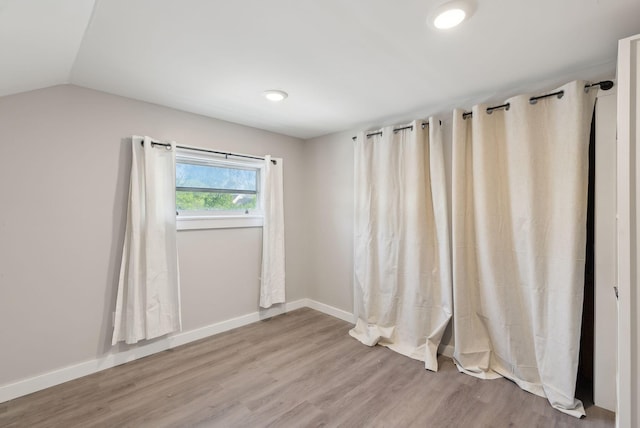 61 Granite St, Bath, ME 04530 - unfurnished room with wood finished floors, baseboards, and lofted ceiling