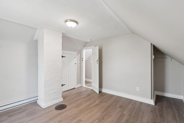 61 Granite St, Bath, ME 04530 - bonus room featuring wood finished floors, a baseboard radiator, lofted ceiling, and baseboards
