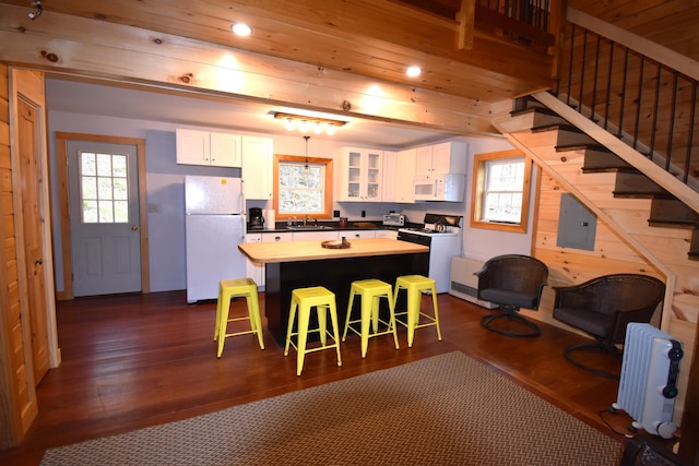106 Shady Ln, Newport, ME 04953 - kitchen with white appliances, white cabinets, radiator, glass insert cabinets, and recessed lighting