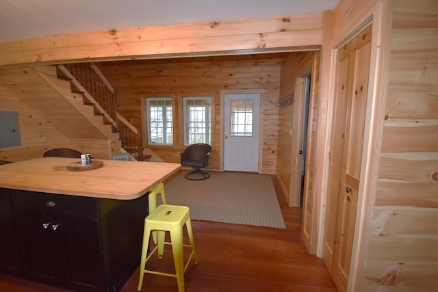 106 Shady Ln, Newport, ME 04953 - kitchen featuring wood walls, light wood finished floors, a breakfast bar area, electric panel, and light countertops