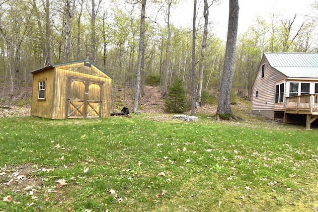 106 Shady Ln, Newport, ME 04953 - view of grassy yard featuring a storage shed, an outbuilding, and a wooden deck