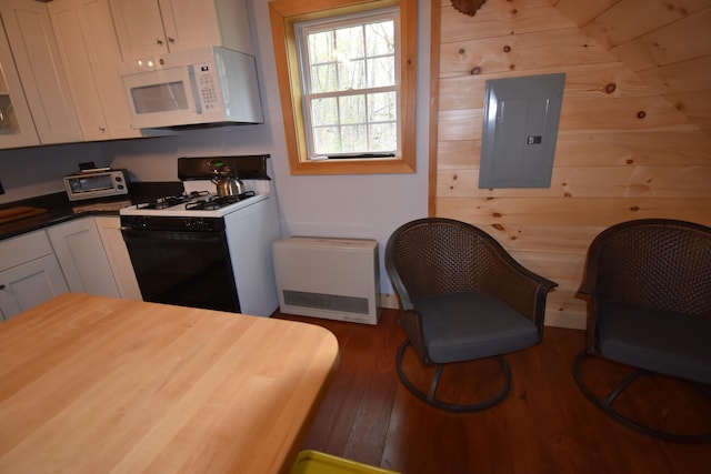 106 Shady Ln, Newport, ME 04953 - kitchen with white microwave, gas range oven, electric panel, white cabinets, and wood finished floors