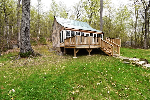 106 Shady Ln, Newport, ME 04953 - back of property with a wooden deck, a yard, stairs, and metal roof