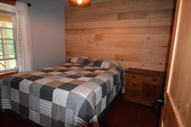 106 Shady Ln, Newport, ME 04953 - bedroom with wooden walls and dark wood-style flooring