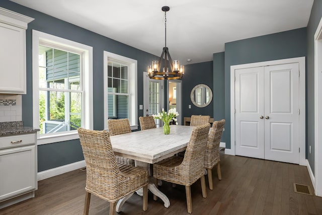 53 Ross Rd, Kennebunk, ME 04043 - dining space with a chandelier, dark wood-style floors, and baseboards