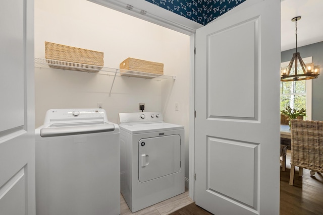 53 Ross Rd, Kennebunk, ME 04043 - laundry room featuring washing machine and dryer, a chandelier, and light wood-style flooring