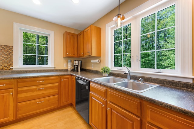 400 Chopps Cross Rd, Woolwich, ME 04579 - kitchen with black dishwasher, a sink, dark countertops, light wood finished floors, and pendant lighting