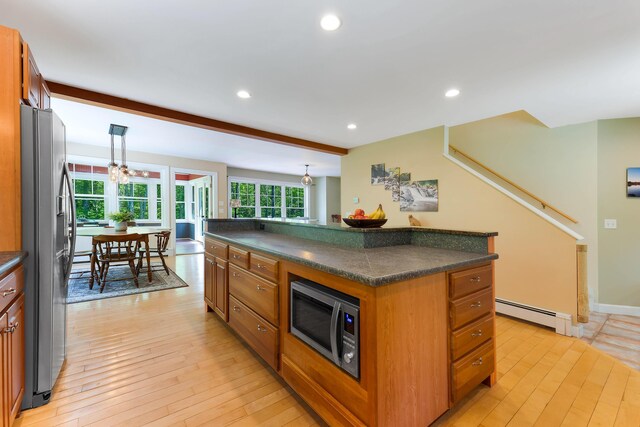 400 Chopps Cross Rd, Woolwich, ME 04579 - kitchen with appliances with stainless steel finishes, a baseboard heating unit, dark countertops, light wood-style floors, and brown cabinets