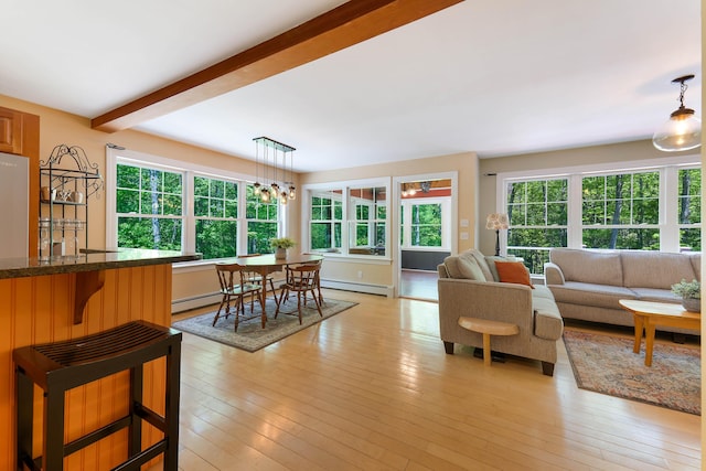 400 Chopps Cross Rd, Woolwich, ME 04579 - living area featuring a baseboard radiator, plenty of natural light, beam ceiling, light wood-style flooring, and a chandelier