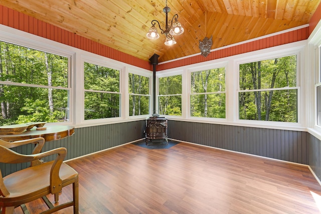 400 Chopps Cross Rd, Woolwich, ME 04579 - sunroom / solarium featuring a wood stove, wood finished floors, plenty of natural light, vaulted ceiling, and wood walls