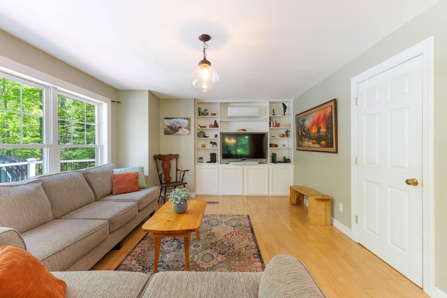 400 Chopps Cross Rd, Woolwich, ME 04579 - living room featuring an AC wall unit, light wood finished floors, and baseboards