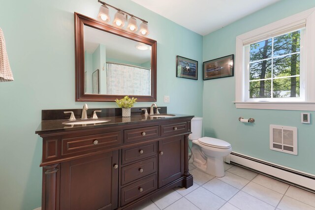 400 Chopps Cross Rd, Woolwich, ME 04579 - bathroom featuring a baseboard heating unit, double vanity, tile patterned flooring, toilet, and curtained shower