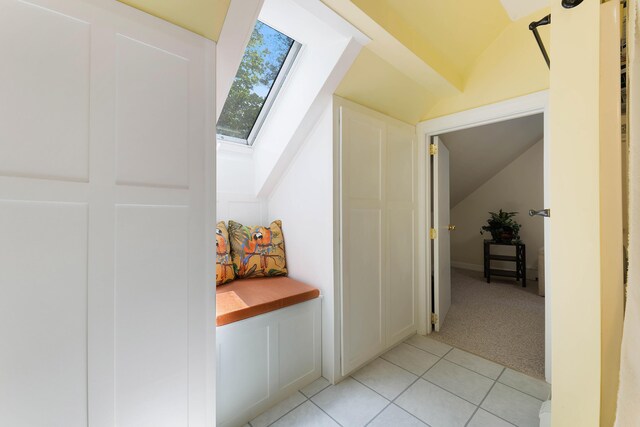 400 Chopps Cross Rd, Woolwich, ME 04579 - hall featuring a skylight, lofted ceiling, light tile patterned floors, and light carpet