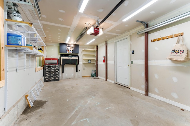 400 Chopps Cross Rd, Woolwich, ME 04579 - garage featuring a garage door opener and baseboards