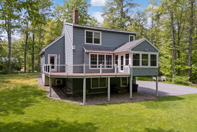 400 Chopps Cross Rd, Woolwich, ME 04579 - back of house with a chimney, a wooden deck, a sunroom, roof with shingles, and a yard