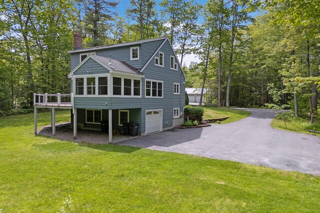 400 Chopps Cross Rd, Woolwich, ME 04579 - rear view of property featuring a chimney, driveway, a sunroom, a lawn, and a wooden deck