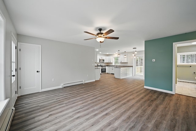 457 S Reynolds Rd, Winslow, ME 04901 - unfurnished living room with a baseboard heating unit, a ceiling fan, wood finished floors, a baseboard radiator, and recessed lighting