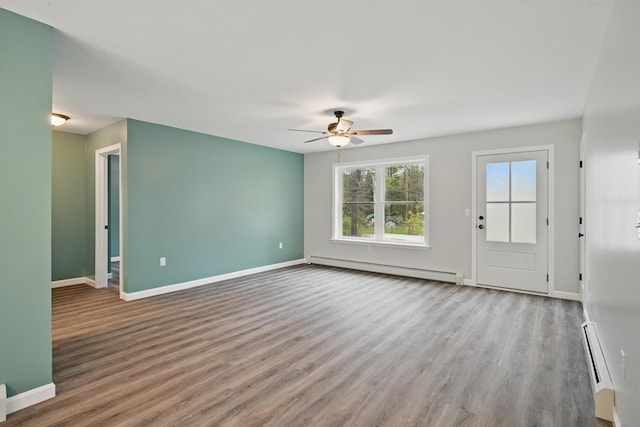 457 S Reynolds Rd, Winslow, ME 04901 - unfurnished living room featuring a baseboard heating unit, a ceiling fan, and wood finished floors