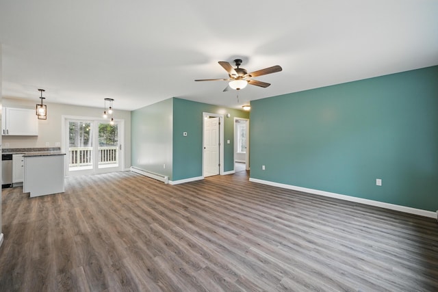 457 S Reynolds Rd, Winslow, ME 04901 - unfurnished living room featuring baseboard heating, ceiling fan, baseboards, and dark wood finished floors