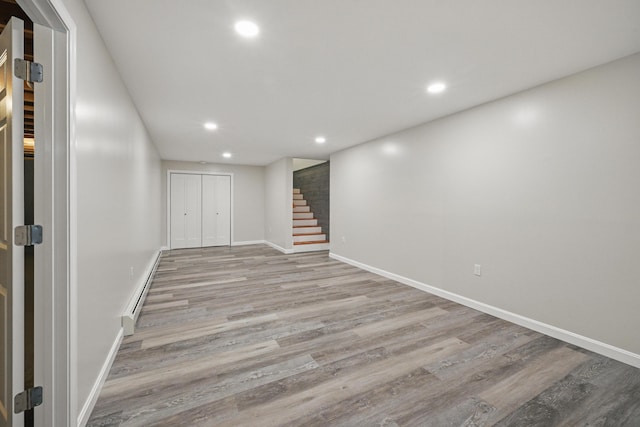 457 S Reynolds Rd, Winslow, ME 04901 - finished basement featuring stairs, wood finished floors, recessed lighting, baseboards, and a baseboard radiator